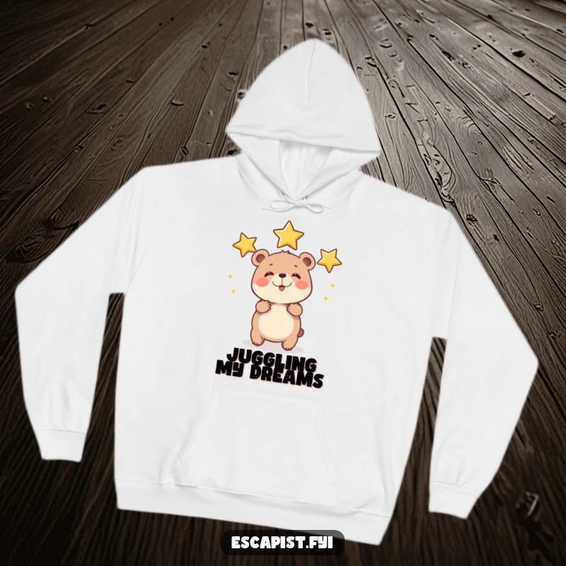 Funny bear cub hoodie featuring a small, round cub happily juggling shiny stars with exaggerated effort, offering warmth and a dose of cosmic aspiration.